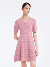 a woman in pink V-neck short dress